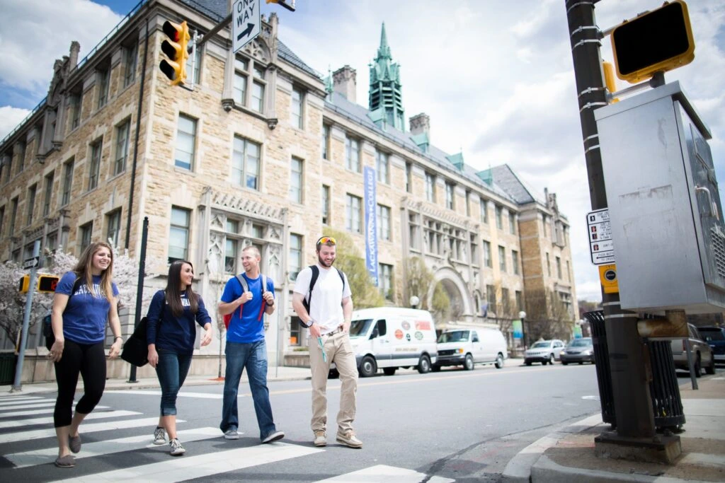 College Students Walking On The Crosswalk